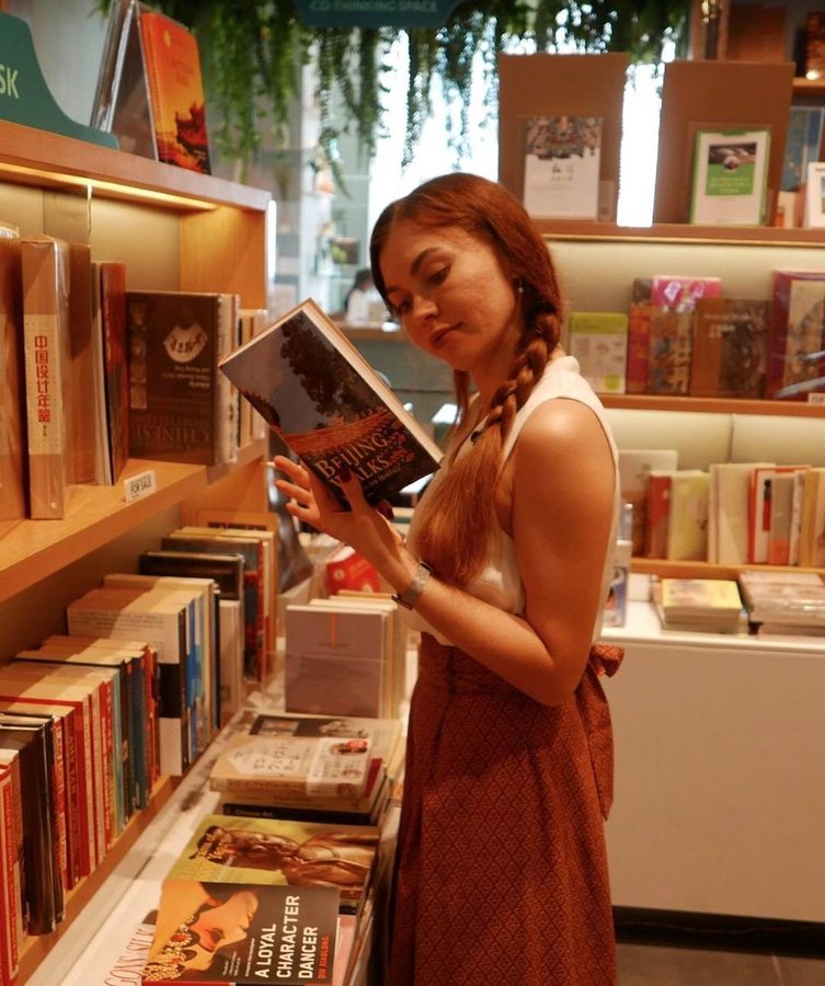 Alisa reading in a bookshop