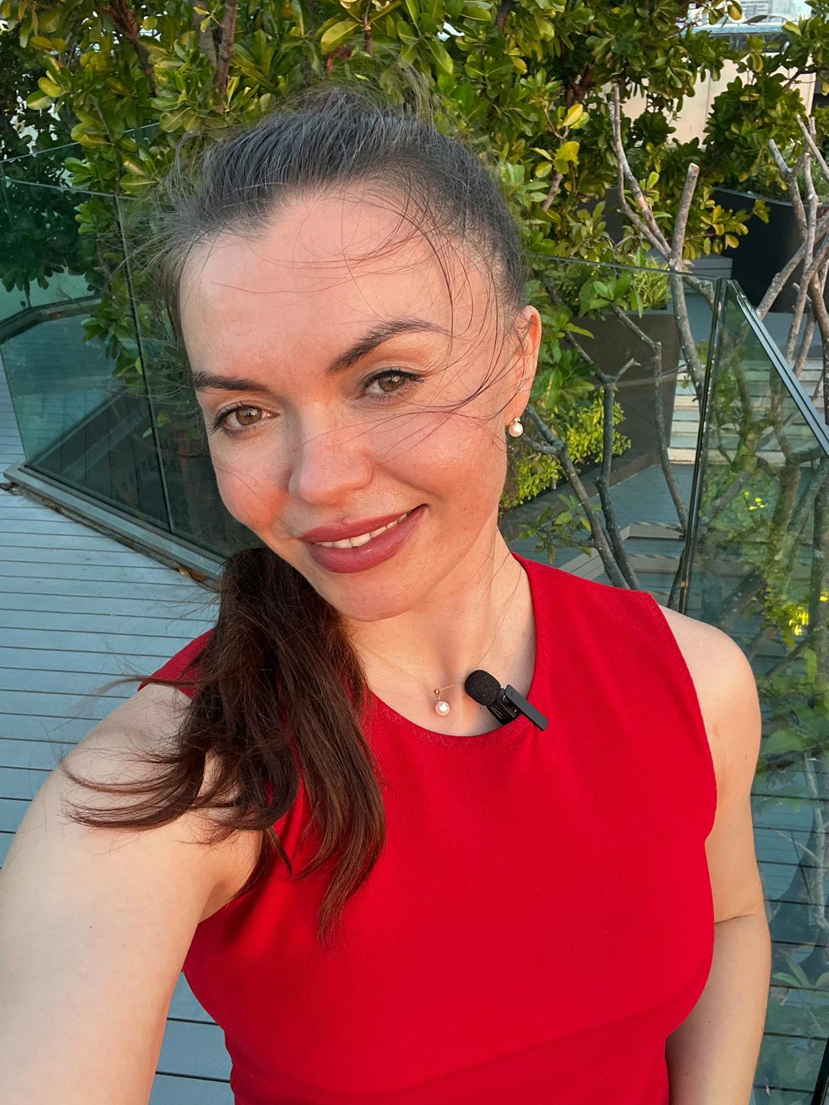 Alisa wearing a lavalier microphone, ready to present